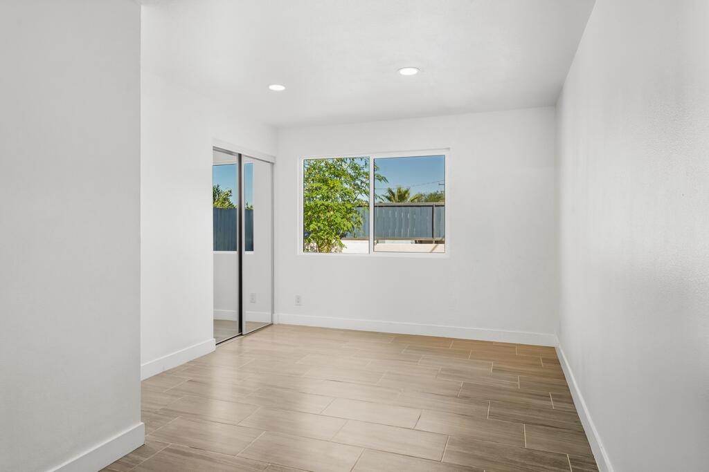 38855 Paradise Way Cathedral City, CA 92234 - Photo 31 of 67 an empty room with wooden floor and windows