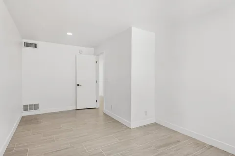 a work room with furniture and a potted plant