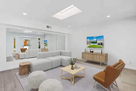 a front view of a house with a yard and fountain