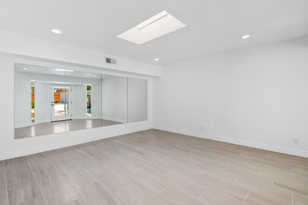 38855 Paradise Way Cathedral City, CA 92234 - Photo 38 of 67 wooden floor in an empty room with a window