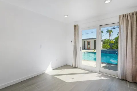an aerial view of residential houses with outdoor space and parking