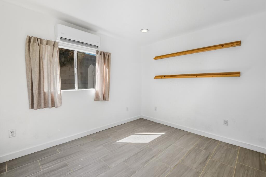 38855 Paradise Way Cathedral City, CA 92234 - Photo 43 of 67 an empty room with wooden floor and windows