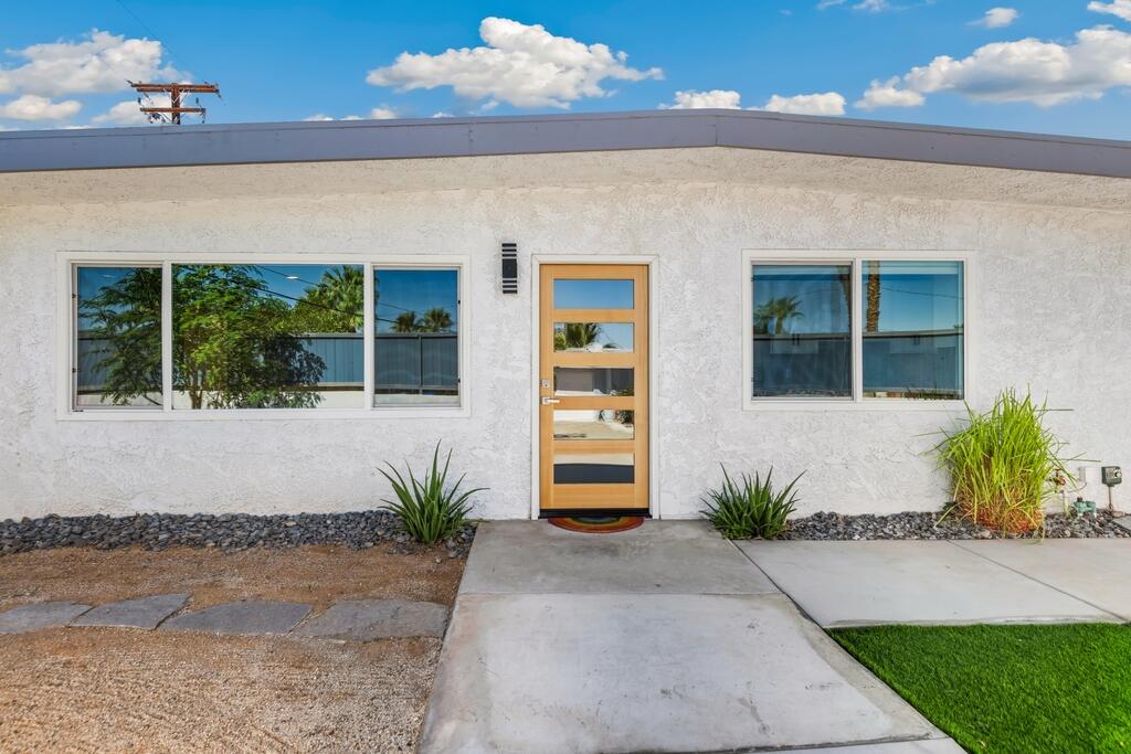 38855 Paradise Way Cathedral City, CA 92234 - Photo 5 of 67 a front view of a house with a yard and potted plants