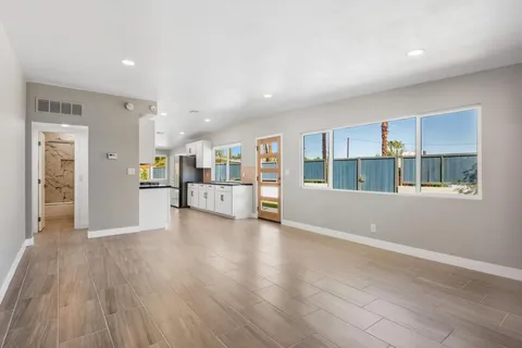 a large kitchen with stainless steel appliances granite countertop a stove a sink and a granite counter tops