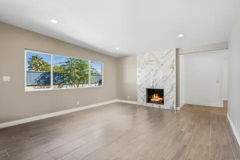 a kitchen with granite countertop a stove a sink and a refrigerator