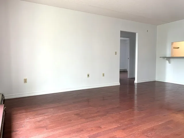 a view of a room with wooden floor