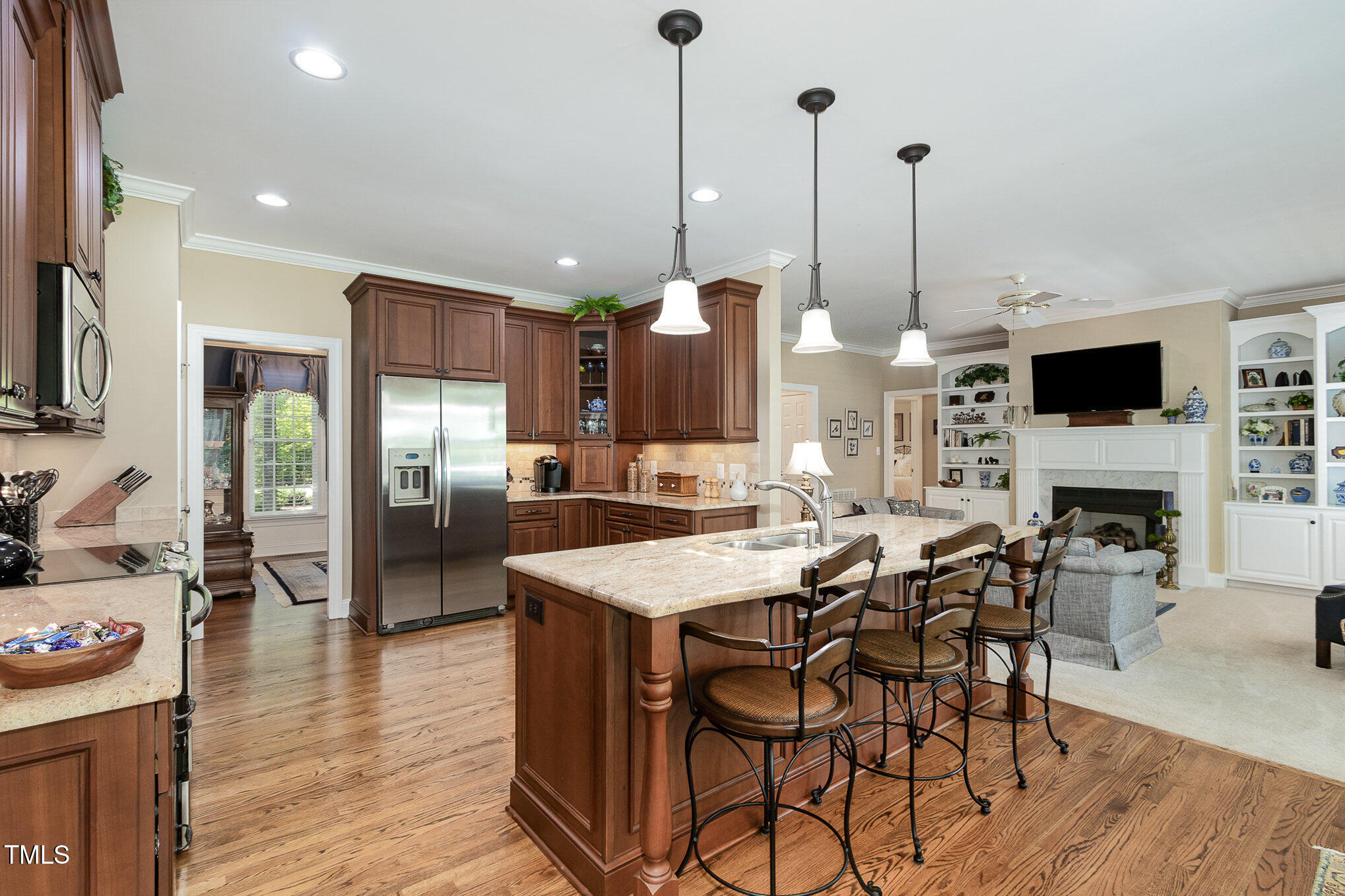 8304 Epping Forest Way Wake Forest, NC 27587 - Photo 13 of 41 a view of a dining room and livingroom with furniture wooden floor a chandelier