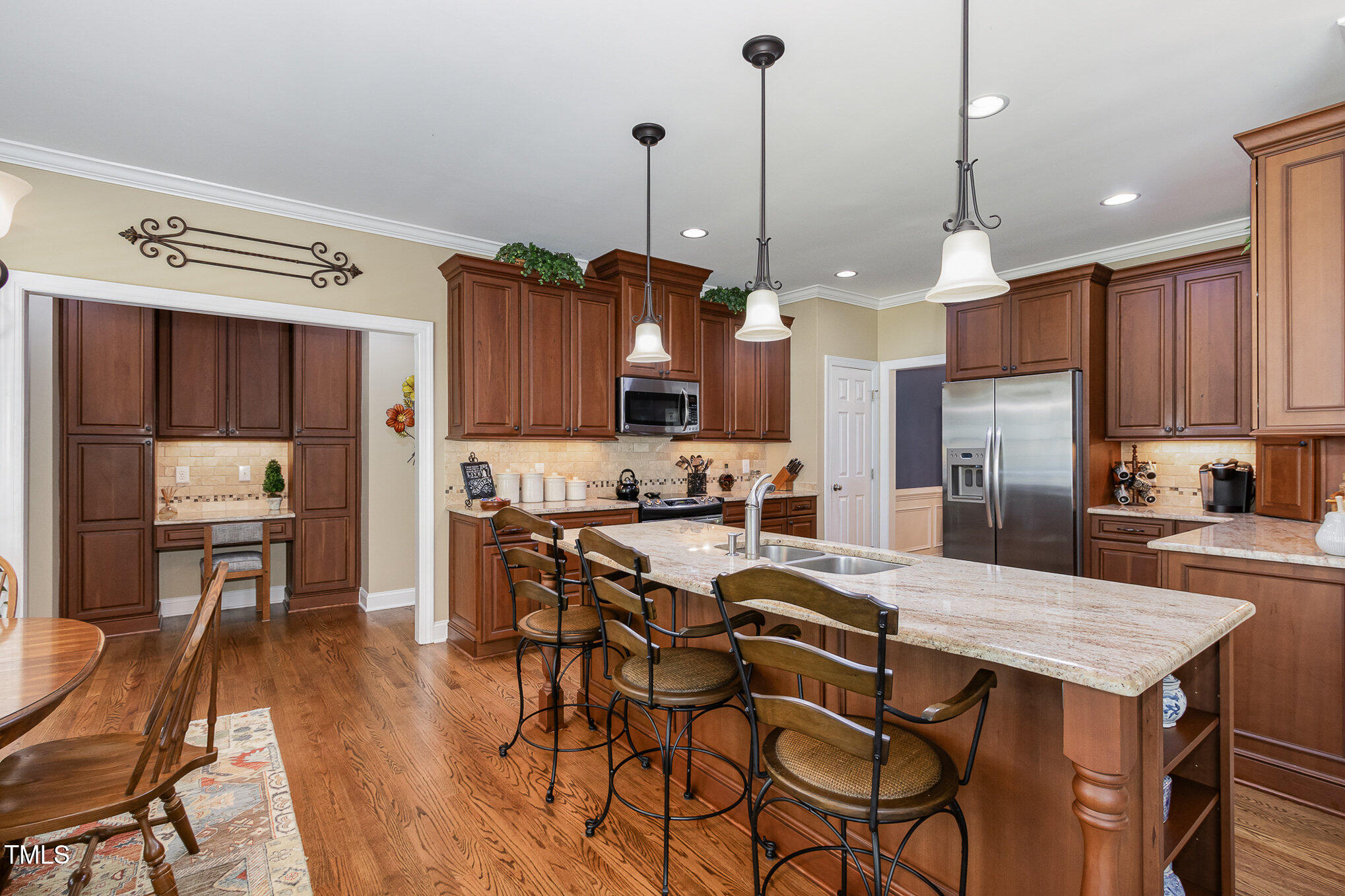 8304 Epping Forest Way Wake Forest, NC 27587 - Photo 14 of 41 a kitchen with granite countertop a table chairs stainless steel appliances and cabinets