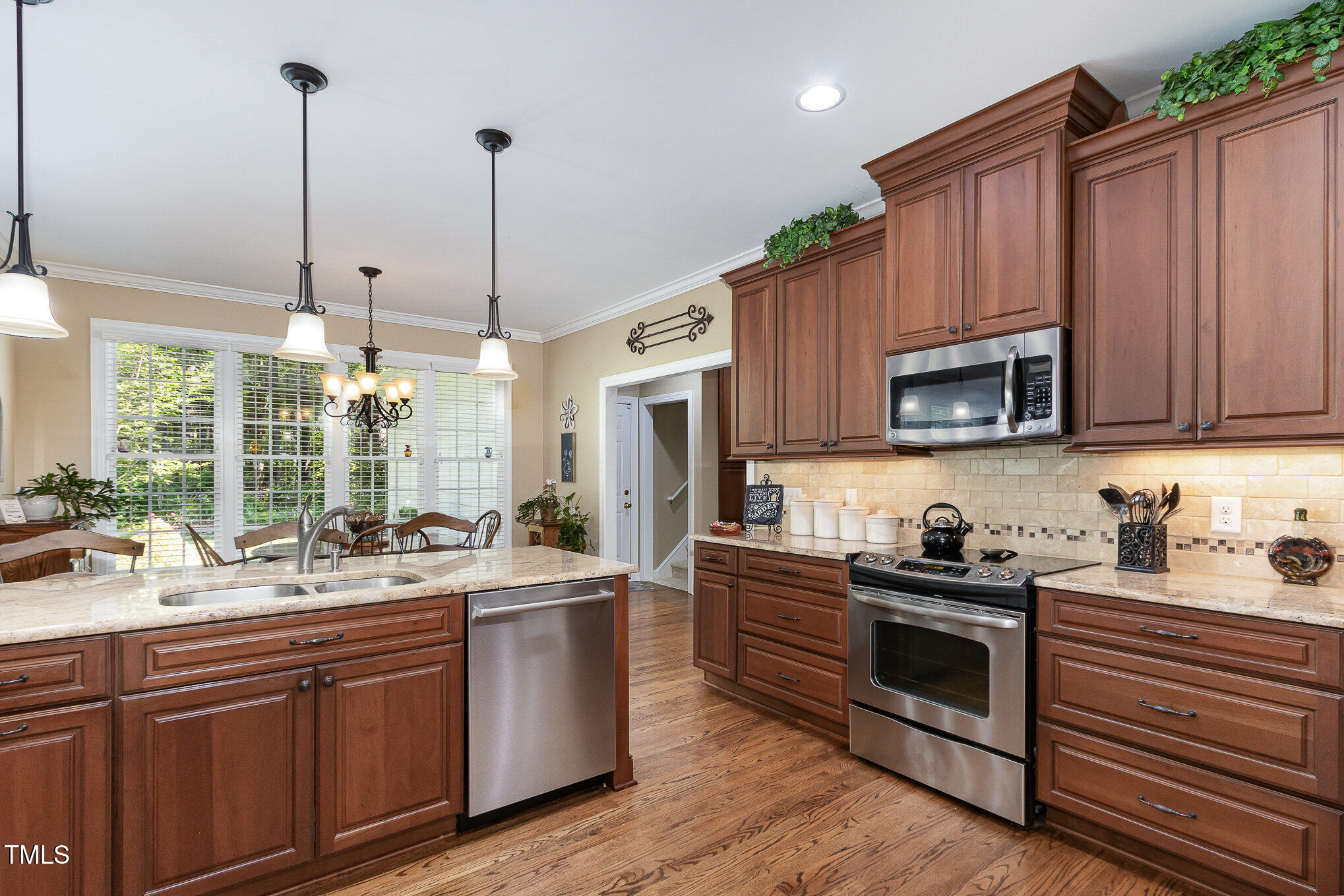 8304 Epping Forest Way Wake Forest, NC 27587 - Photo 15 of 41 a kitchen with stainless steel appliances a sink stove and cabinets