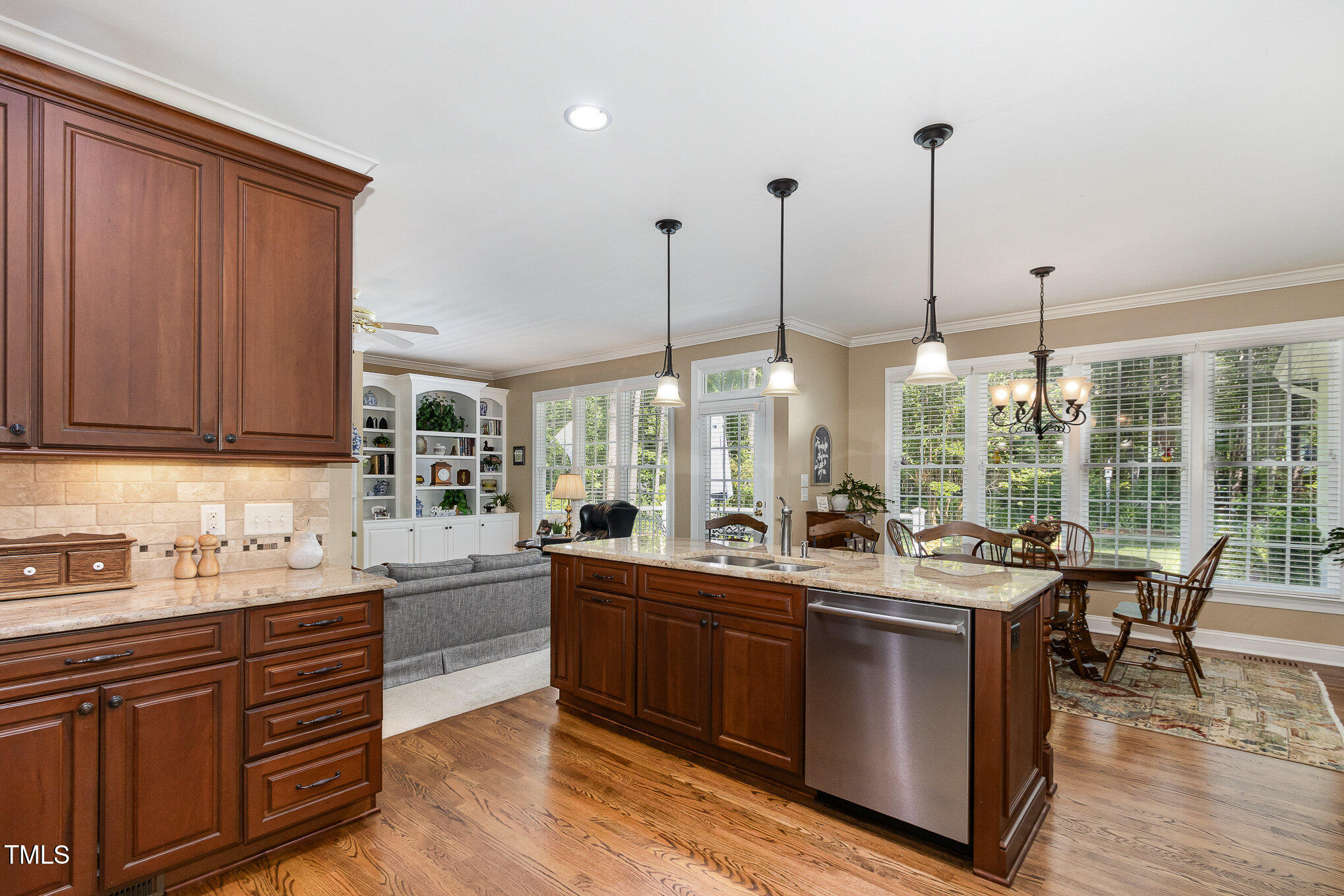 8304 Epping Forest Way Wake Forest, NC 27587 - Photo 16 of 41 a room with stainless steel appliances kitchen island granite countertop a sink and cabinets