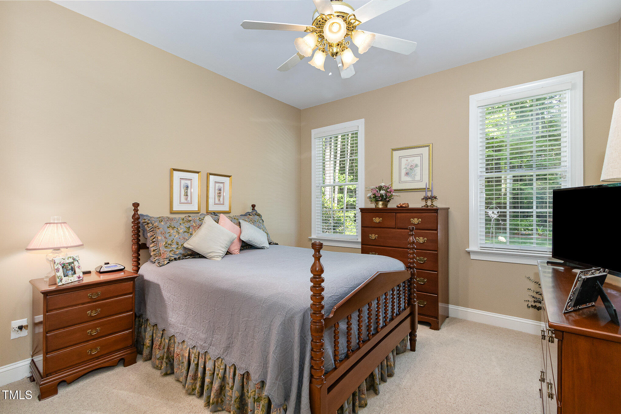 8304 Epping Forest Way Wake Forest, NC 27587 - Photo 25 of 41 a bedroom with a bed and a chandelier