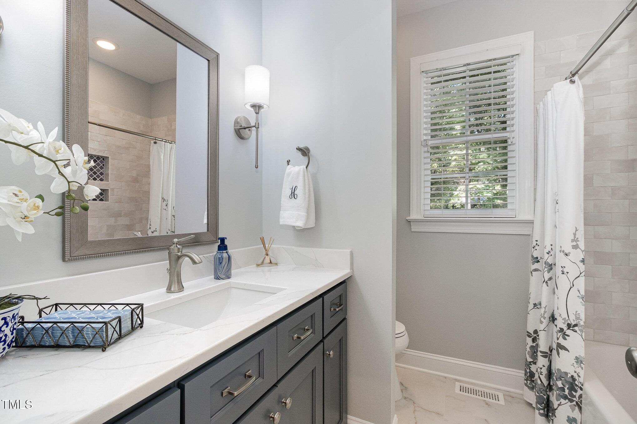 8304 Epping Forest Way Wake Forest, NC 27587 - Photo 26 of 41 a bathroom with a granite countertop sink a toilet and shower