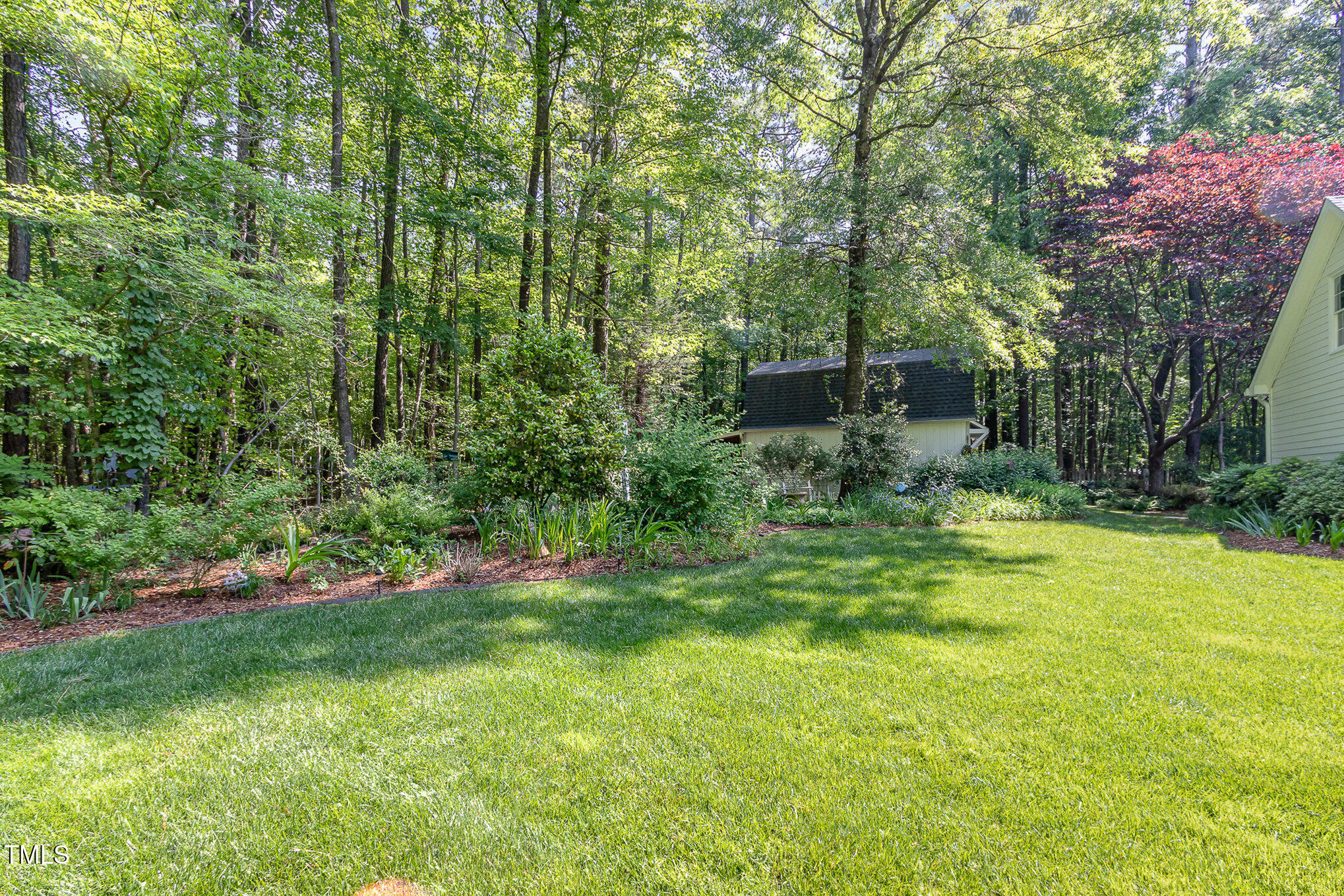 8304 Epping Forest Way Wake Forest, NC 27587 - Photo 37 of 41 a view of a backyard with plants and a patio