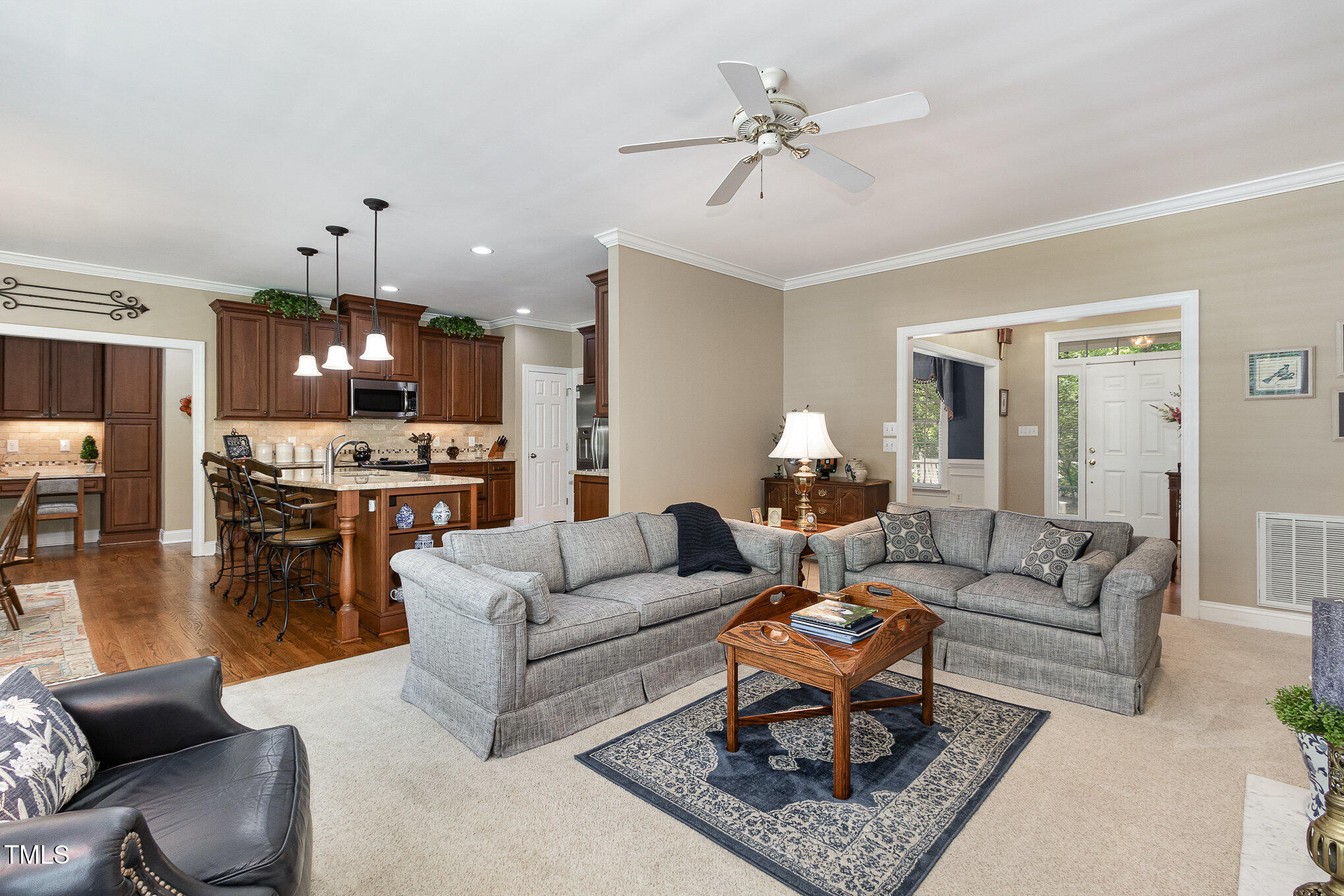 8304 Epping Forest Way Wake Forest, NC 27587 - Photo 10 of 41 a living room with furniture kitchen view and a chandelier