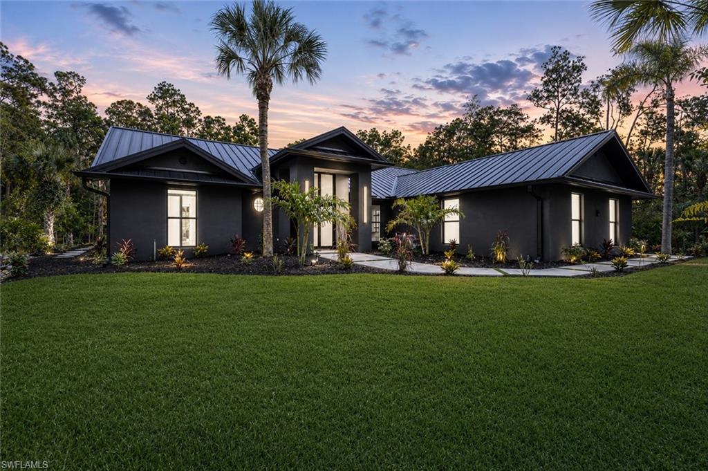 4521 3rd Avenue Northwest Naples, FL 34119 - Photo 1 of 46 a front view of house with yard and green space