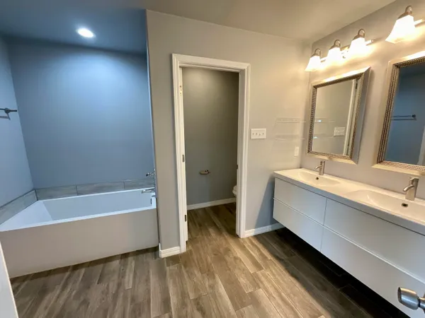 a bathroom with a bathtub and a sink
