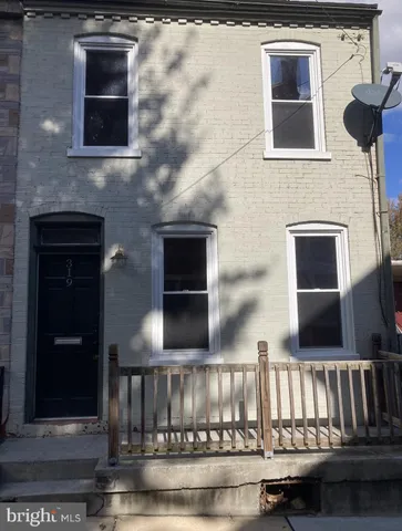 a view of front door of house with stairs