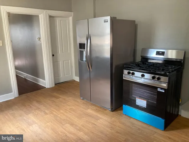 a kitchen with a stove and a refrigerator