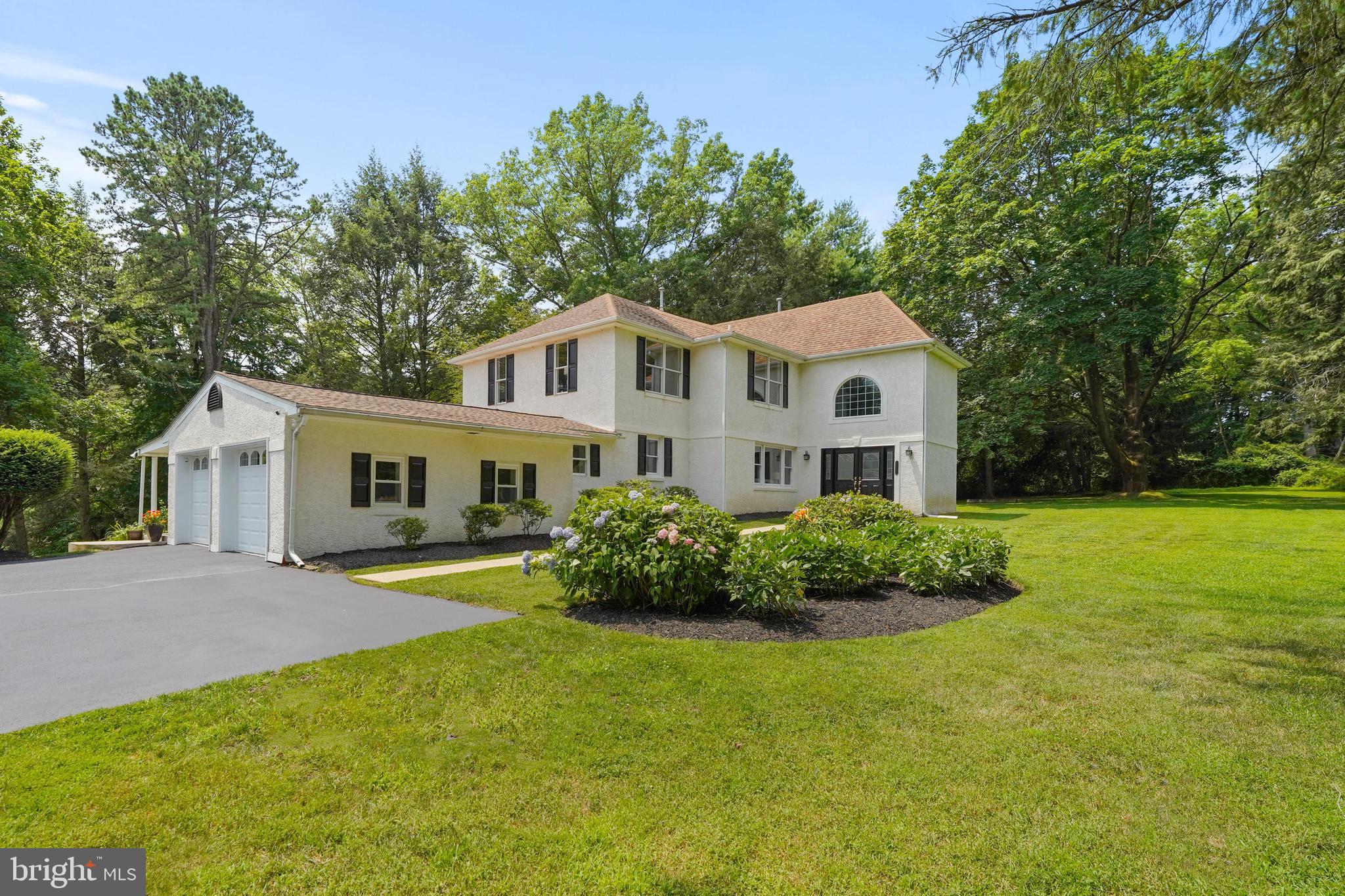 a front view of house with yard and green space