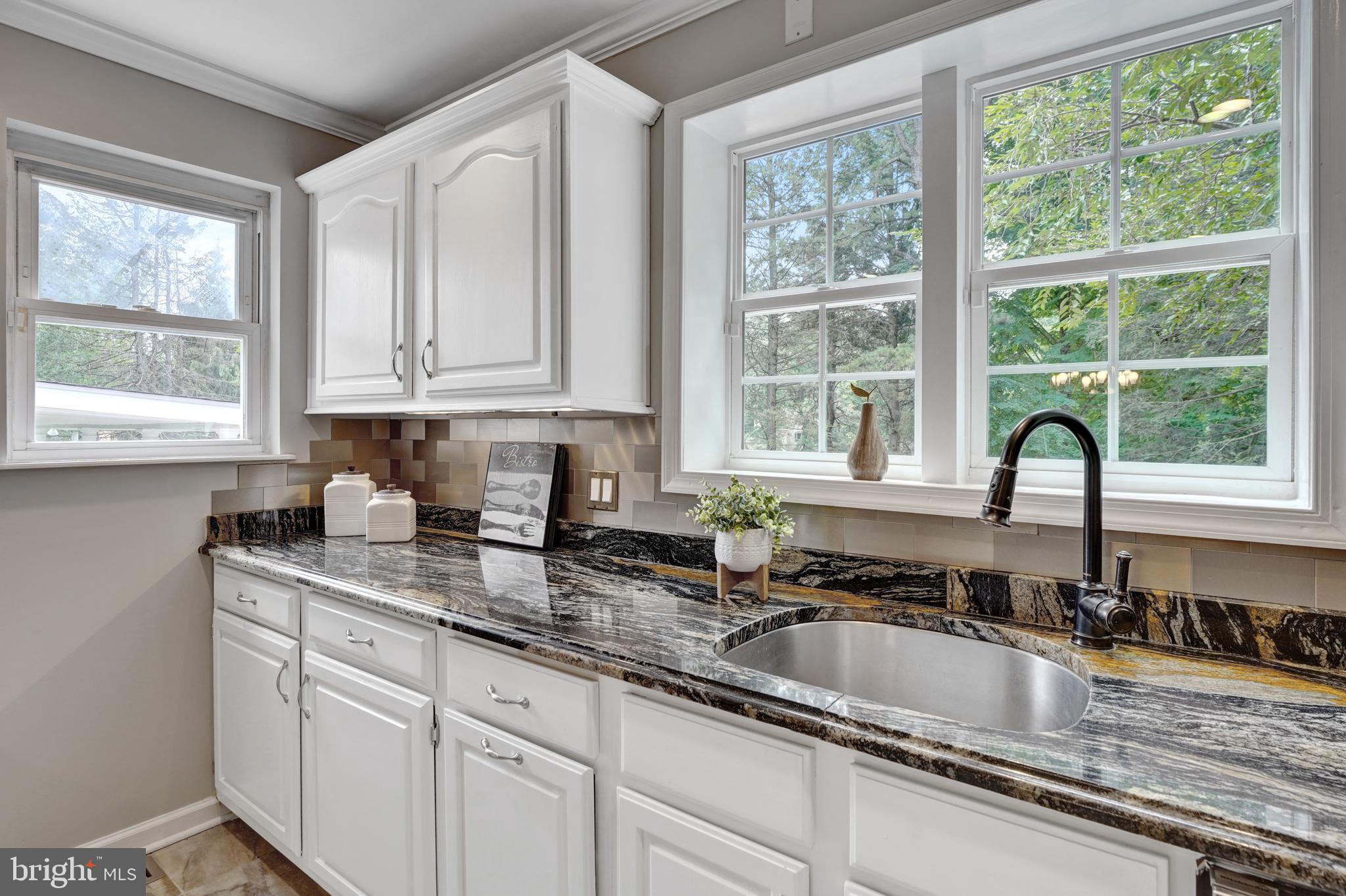 922 Hunt Road Radnor, PA 19008 - Photo 16 of 59 a kitchen with granite countertop a sink and a window