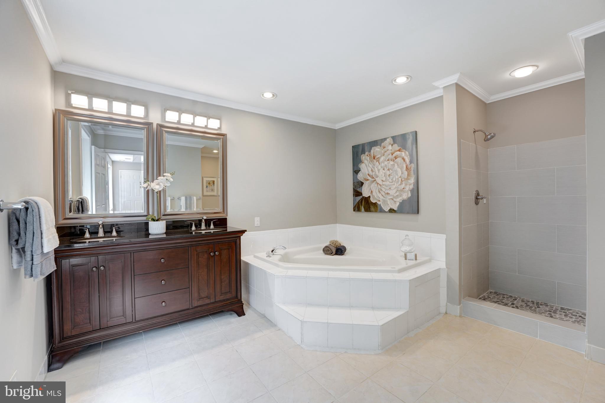 922 Hunt Road Radnor, PA 19008 - Photo 36 of 59 a spacious bathroom with a tub a double vanity sink and mirror