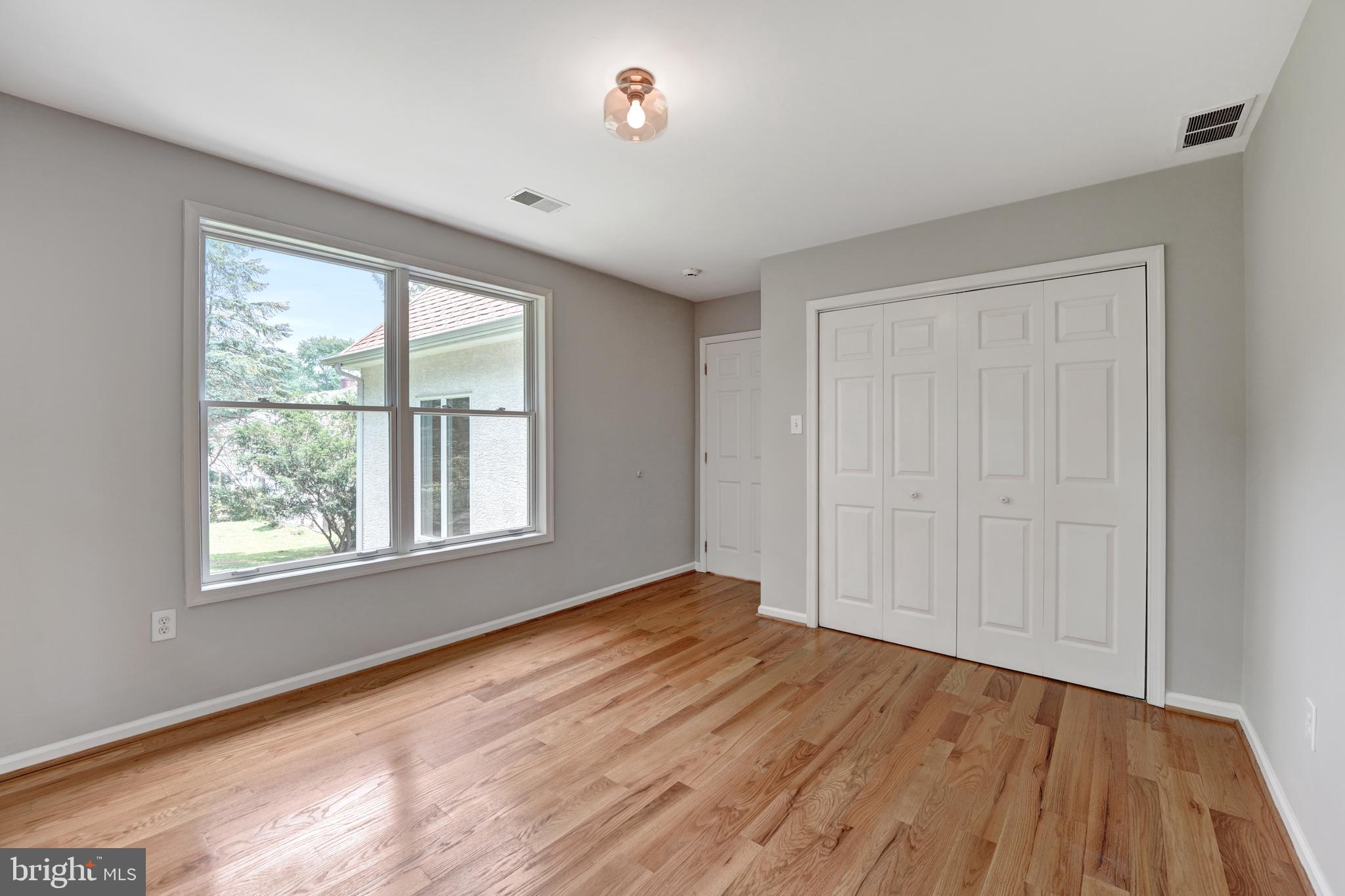 922 Hunt Road Radnor, PA 19008 - Photo 40 of 59 a view of an empty room with wooden floor and a window