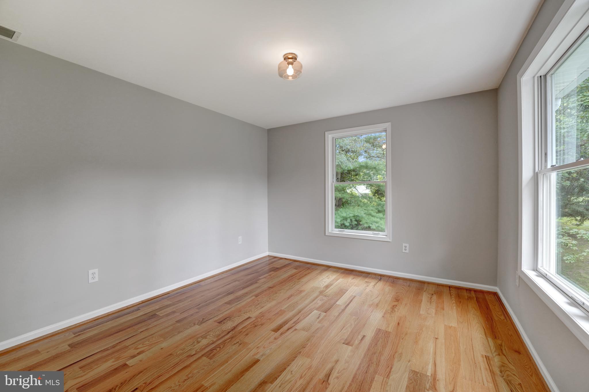 922 Hunt Road Radnor, PA 19008 - Photo 41 of 59 an empty room with wooden floor and windows