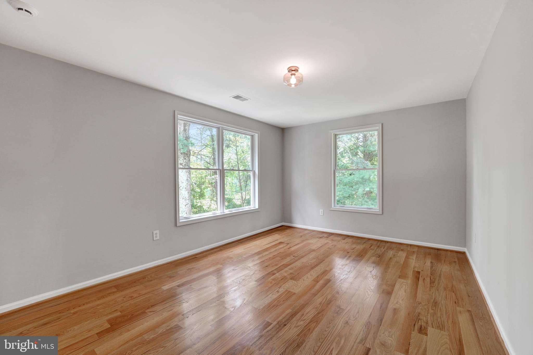 922 Hunt Road Radnor, PA 19008 - Photo 45 of 59 a view of an empty room with wooden floor and a window