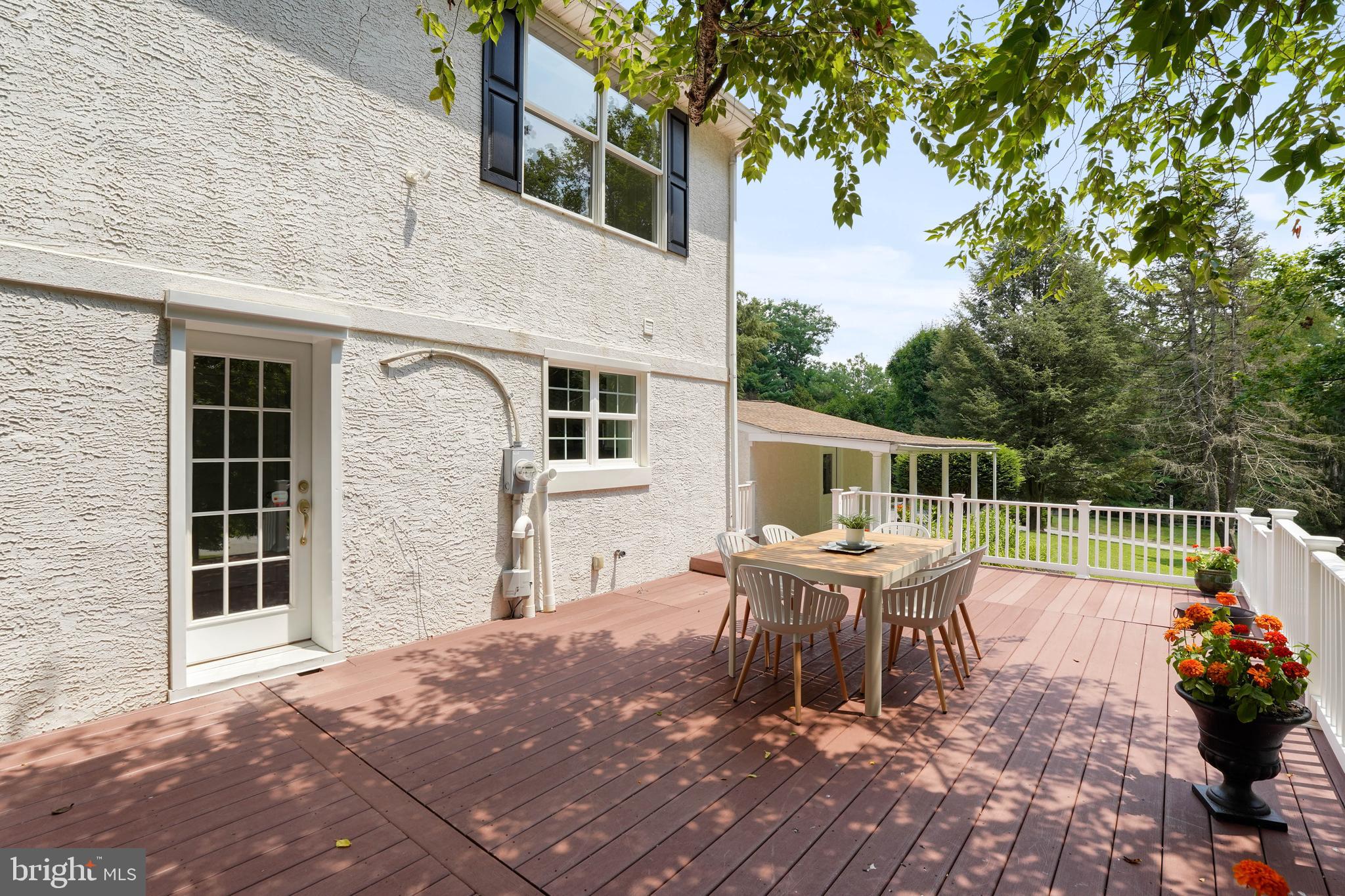 922 Hunt Road Radnor, PA 19008 - Photo 50 of 59 a view of a patio with table and chairs potted plants and large tree