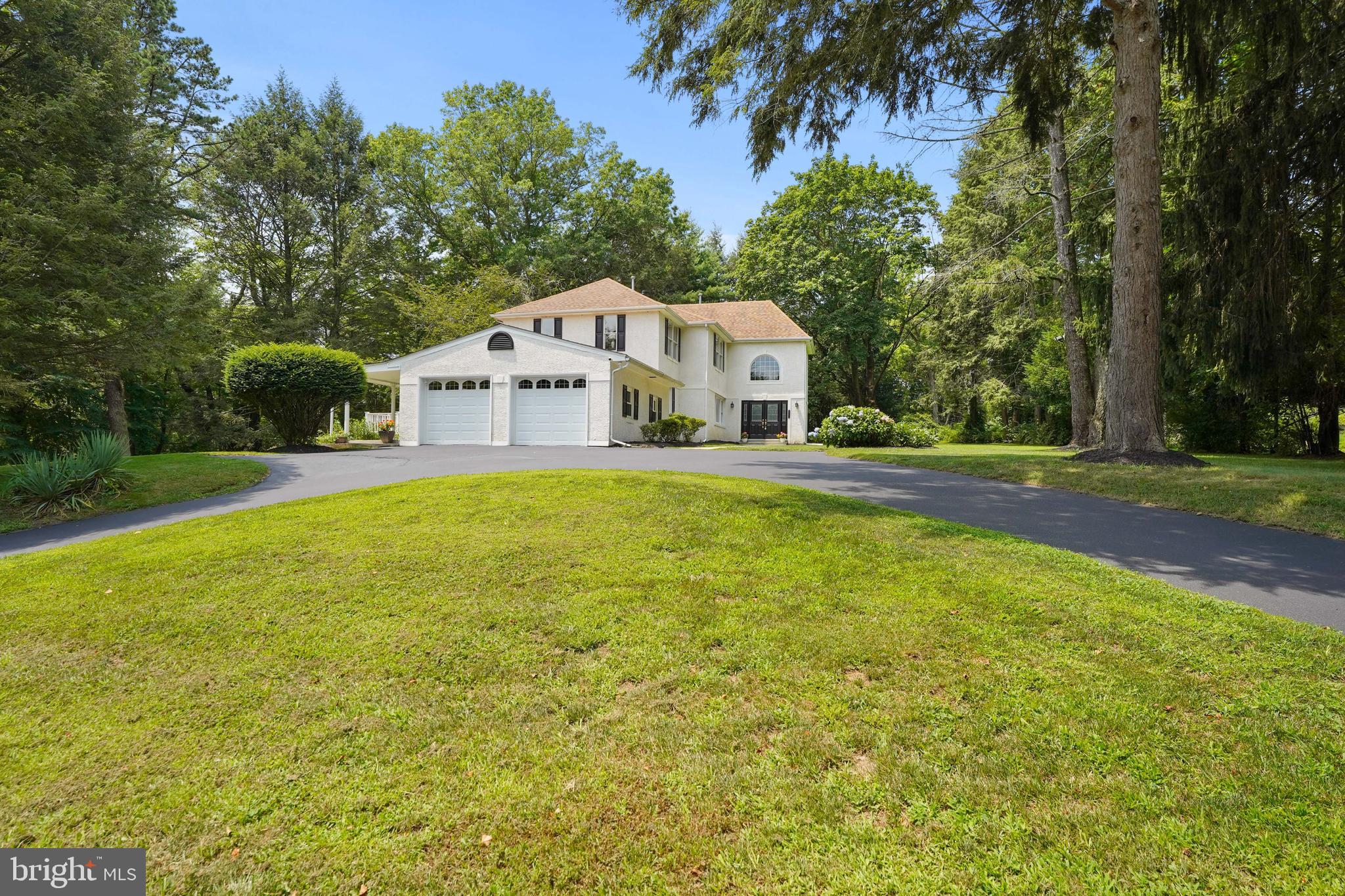 922 Hunt Road Radnor, PA 19008 - Photo 52 of 59 a front view of a house with a yard and trees