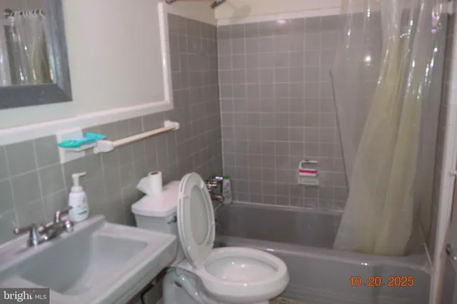 a white toilet sitting next to a bathroom sink