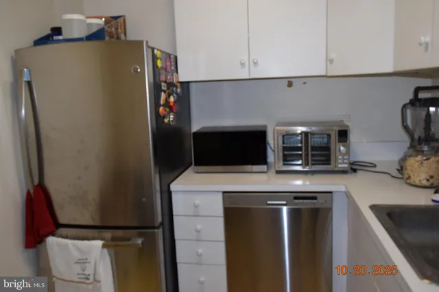 a kitchen with a refrigerator and a sink