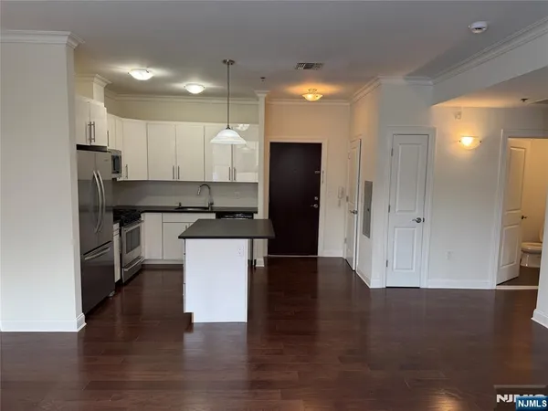 a kitchen with stainless steel appliances a refrigerator and a stove top oven