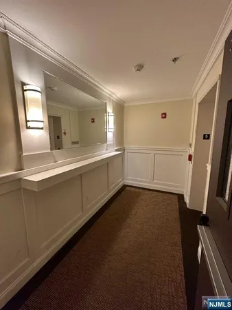 a room with a sink and mirror