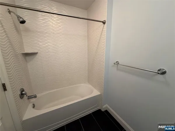 a bathroom with a bathtub and shower