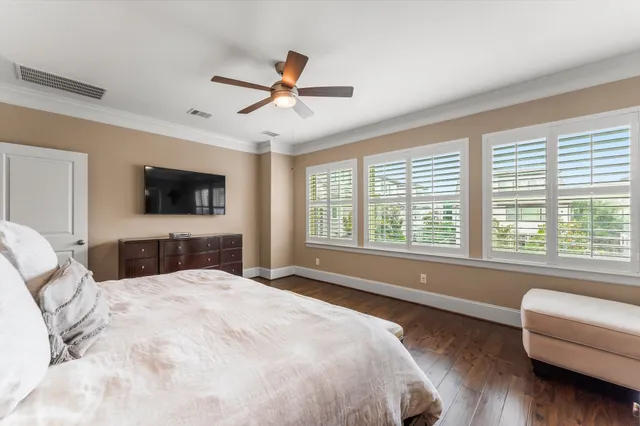 a bedroom with a large bed and a flat screen tv