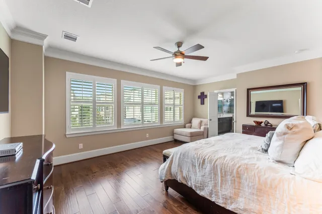 a spacious bedroom with a large bed and a chandelier