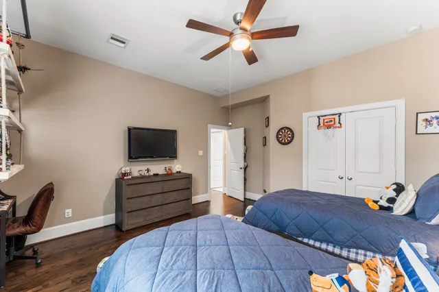 a bedroom with a bed and a flat screen tv