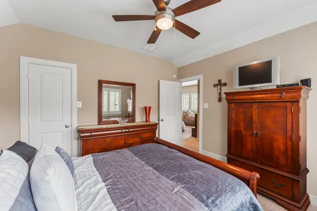 a bedroom with furniture and a flat screen tv