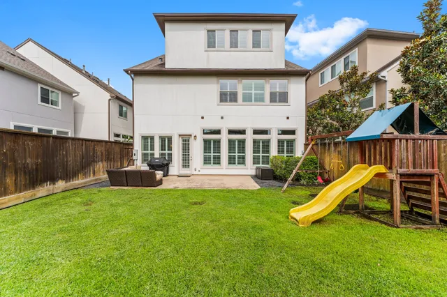 a view of a house with a yard and a deck