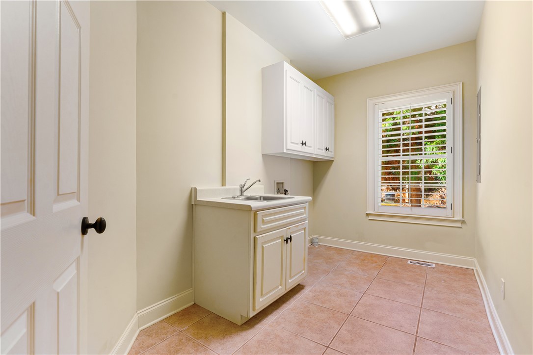 109 Limelight Drive Anderson, SC 29621 - Photo 28 of 34 This functional laundry room features convenient cabinetry and a practical utility sink for everyday tasks.