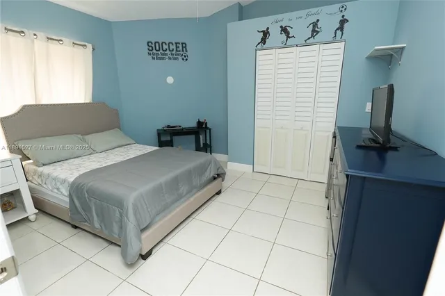 a bedroom with a bed and a desk