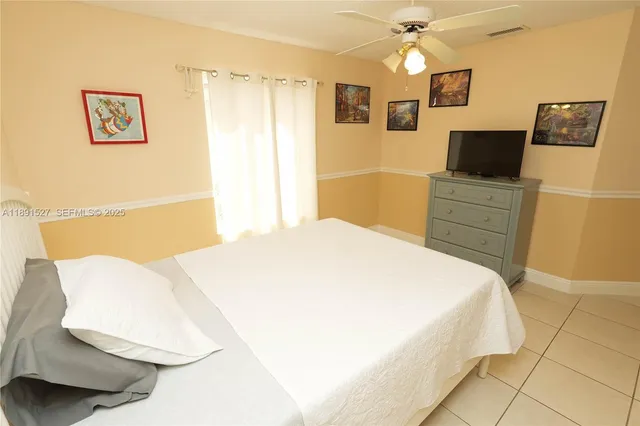 a bedroom with a bed and a television