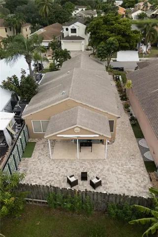 an aerial view of a house with swimming pool and outdoor space