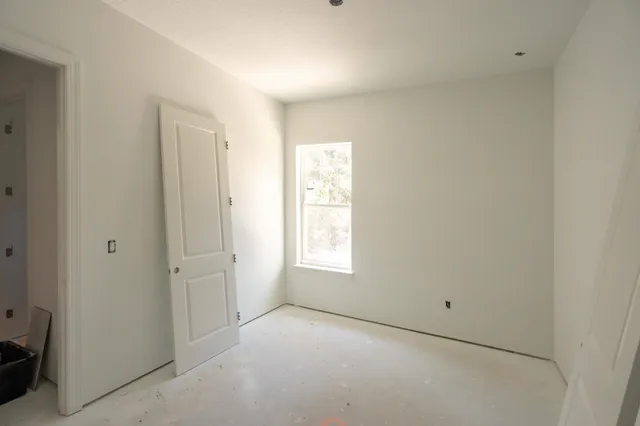 a view of a room with wooden floor and windows