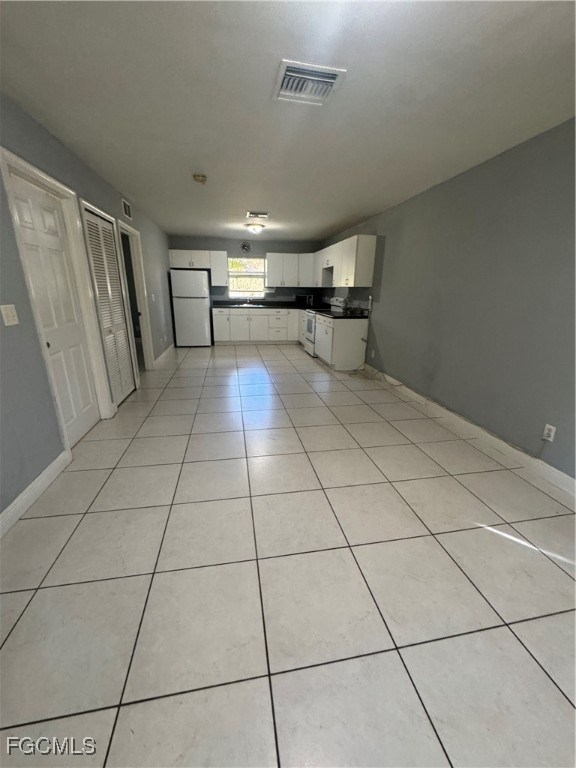 291 16th Street Northeast, Unit 1 Naples, FL 34120 - Photo 18 of 21 a view of a livingroom with kitchen and furniture