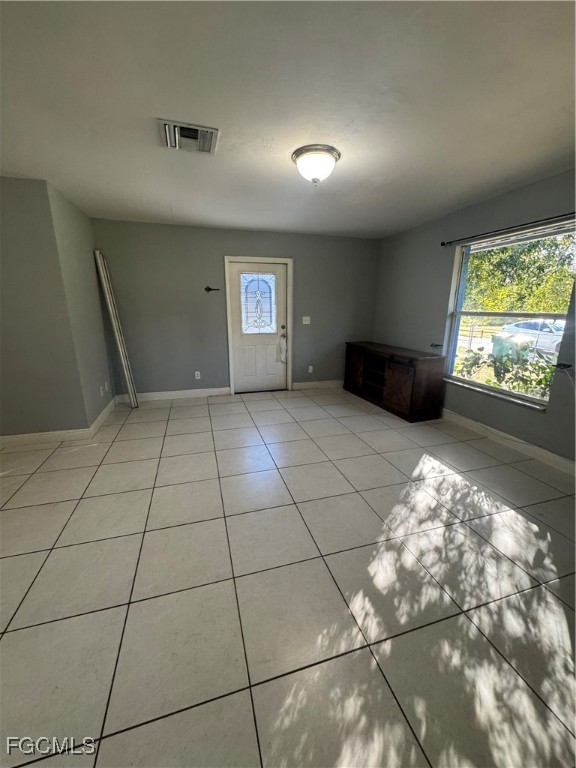 291 16th Street Northeast, Unit 1 Naples, FL 34120 - Photo 5 of 21 a view of wooden floor and windows in a room