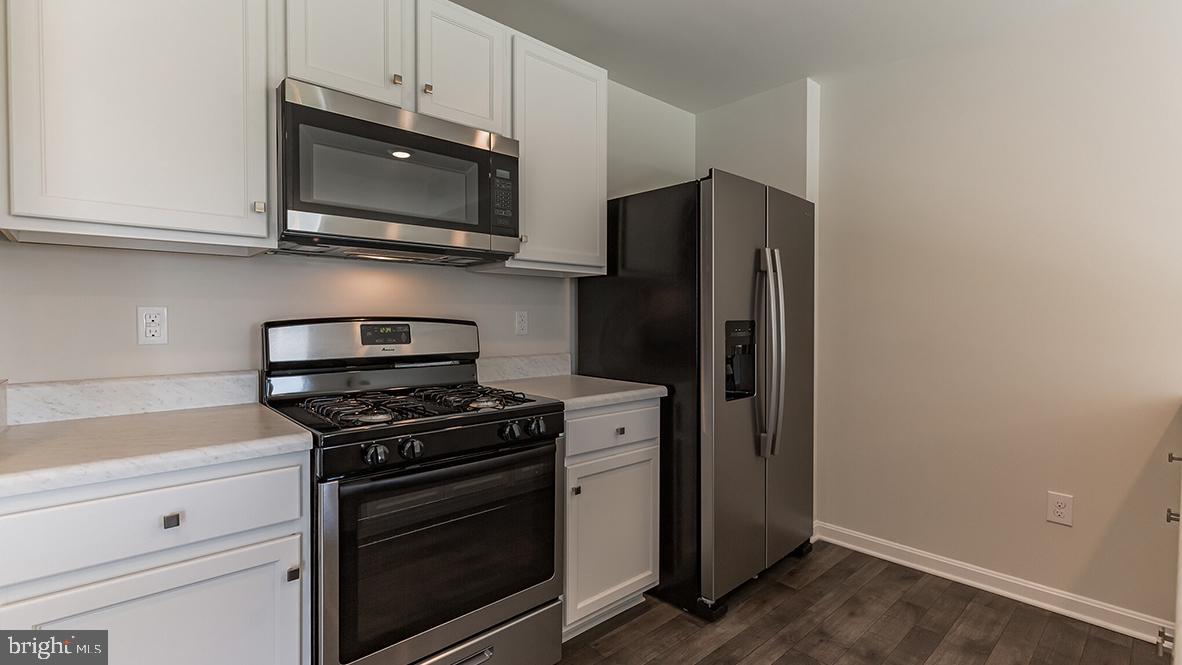 101 Whitman Lane Woodbine, NJ 08270 - Photo 15 of 29 a kitchen with stainless steel appliances white cabinets and a stove top oven
