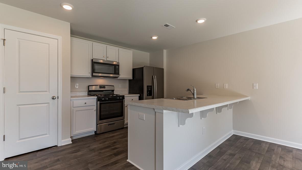 101 Whitman Lane Woodbine, NJ 08270 - Photo 16 of 29 a kitchen with a sink a stove a refrigerator and cabinets