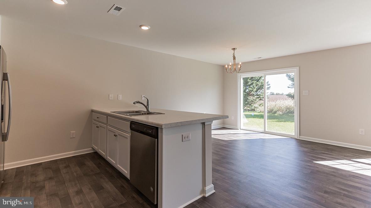 101 Whitman Lane Woodbine, NJ 08270 - Photo 17 of 29 a view of a kitchen sink a stove and wooden floor